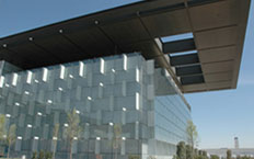 View of the glass façade of the main building of the Telefónica Telecommunications City, Madrid, Spain
